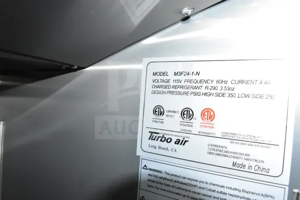 Turbo Air label displaying model M3F24-1-N, voltage 115V, frequency 60Hz, current 4.4A. Refrigerant R-290, depicts safety standards and origin.