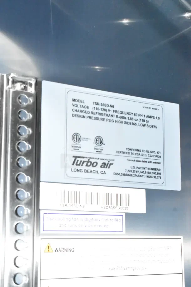Label on Turbo Air refrigeration unit in Rock Solid Cargo trailer; shows model TSR-35SD-N6, voltage info, and safety warnings.