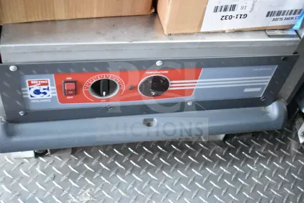 "Metro C5 holding unit with temperature control panel on diamond plate floor inside 2022 Rock Solid Cargo kitchen trailer."
