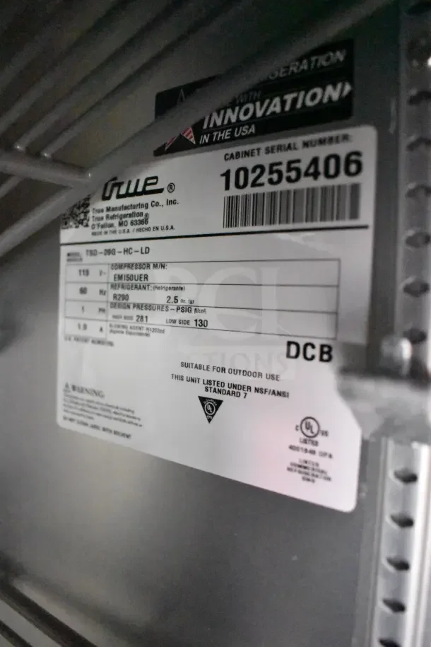 Label inside Rock Solid Cargo trailer showing True Refrigeration model TSD-09G-HC-LD serial 10255406, suitable for outdoor use.