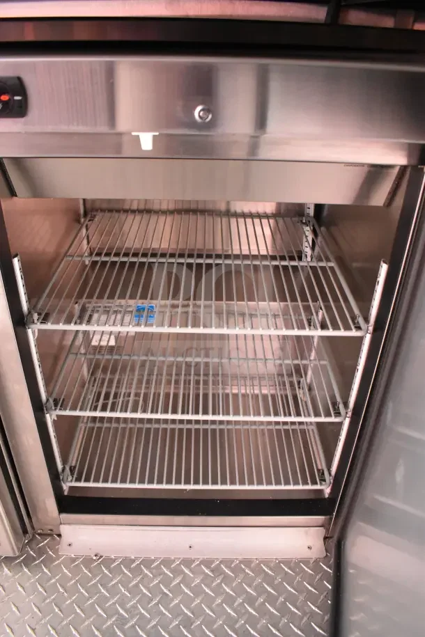 Interior view of a new Rock Solid Cargo 2022 Ghost Kitchen Trailer, showcasing shelving in pristine condition.