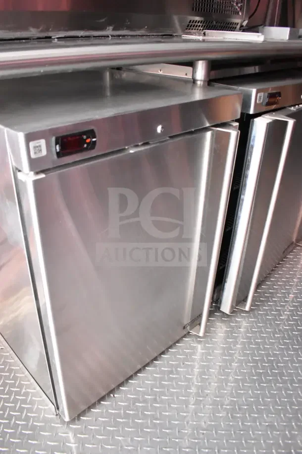 Rock Solid Cargo 8.5x28 Ghost Kitchen Trailer showcasing stainless steel refrigeration units on a diamond plate floor.
