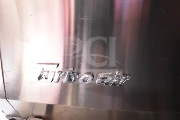 Turbo Air logo on stainless steel surface, part of the 2022 Rock Solid Cargo Ghost Kitchen Trailer with refrigeration suite.