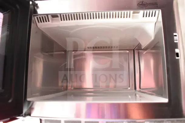 Interior view of a stainless steel compartment in the 2022 Rock Solid Cargo Ghost Kitchen Trailer.