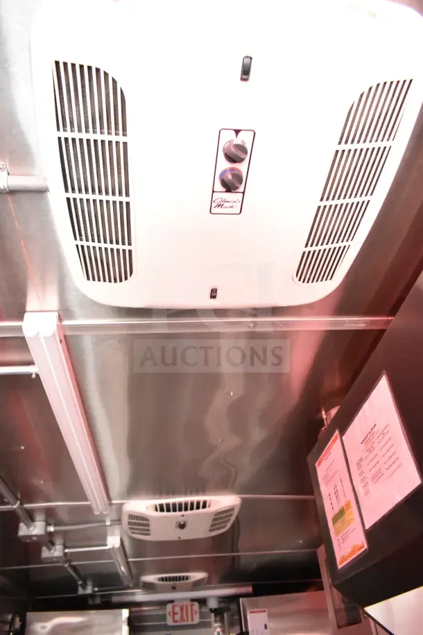 Interior of a 2022 Rock Solid Cargo Ghost Kitchen Trailer, showing ventilation system and stainless steel finish.