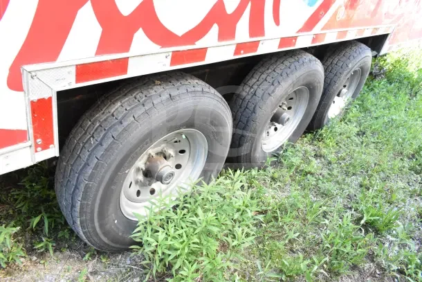 2022 Rock Solid Cargo 8.5x28 trailer wheels and axle detail, featuring six tires with visible treads.