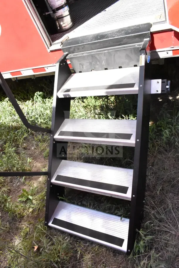 Alt text: Exterior steps of 2022 Rock Solid Cargo Ghost Kitchen Trailer. Sturdy, metal construction with anti-slip design.