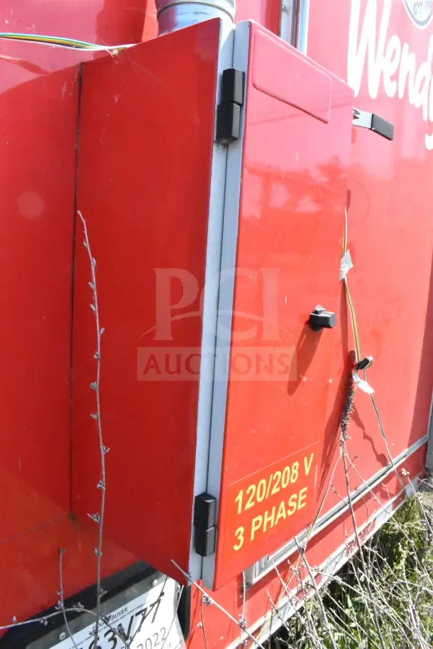 Red Rock Solid Cargo Ghost Kitchen Trailer, exterior panel showing "120/208 V 3 PHASE" marking, part of Wendy's configuration.