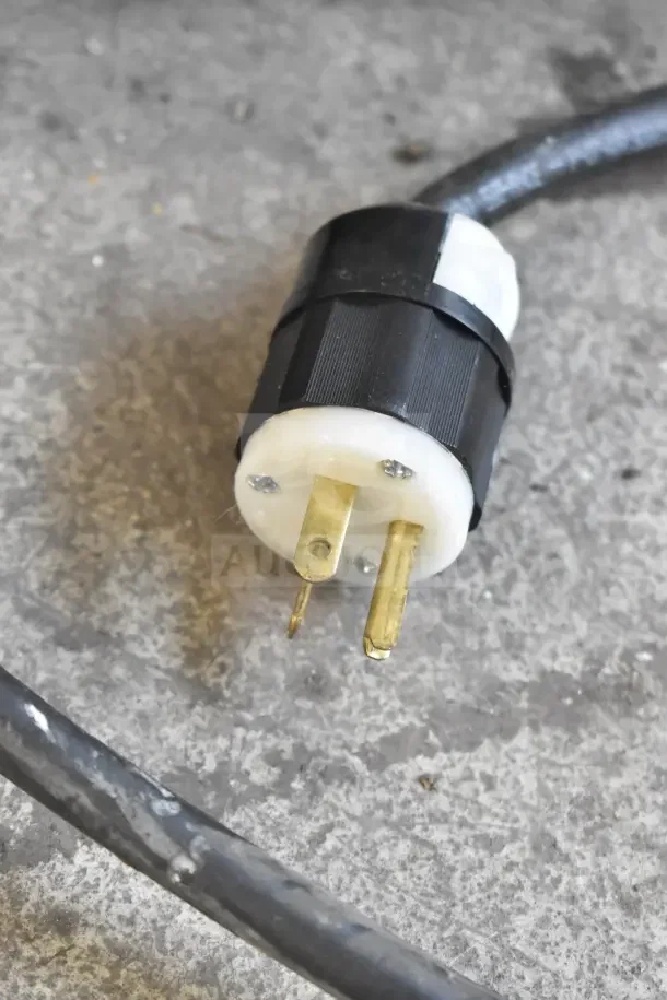 Close-up of a power plug for a Stoelting F131-38I2 soft serve machine. Black and white design, 208-240 volts, 1 phase.