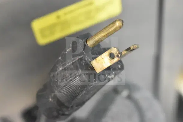 Close-up of a black power plug for the Stoelting SF121-38I2 soft serve ice cream machine.