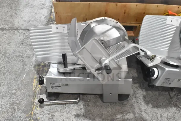Bizerba SE 12 US Commercial Meat Slicer, 120 Volts, 1 Phase. Silver body, labeled for auction, excellent condition.