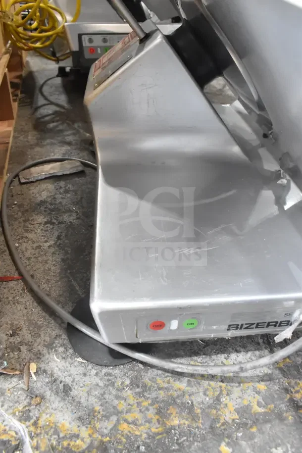 Bizerba SE 12 US commercial meat slicer, 120 volts, 1 phase. Features include power buttons and visible wear marks.