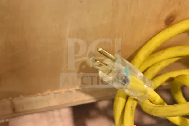 A yellow power cord with a three-prong plug, part of the Bizerba GSP HD meat slicer.