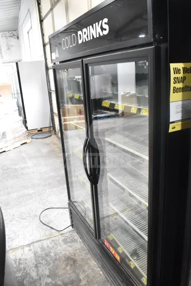 2018 True GDM-49-HC commercial 2-door cooler merchandiser, tested and working, 115 volts, 1 phase, "Cold Drinks" label.