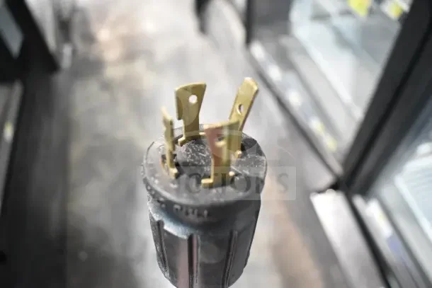 2018 True GDM-72F-HC Commercial Freezer plug close-up, showing four brass prongs. Tested and working condition.