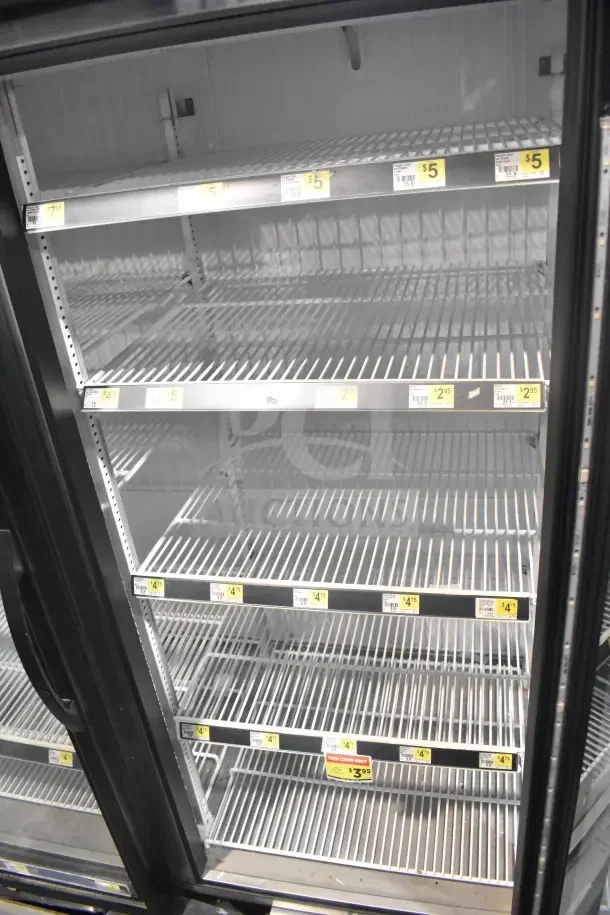 2018 True GDM-72F-HC commercial 3 door reach-in freezer, shelves visible, tested, working condition, seen with price tags.