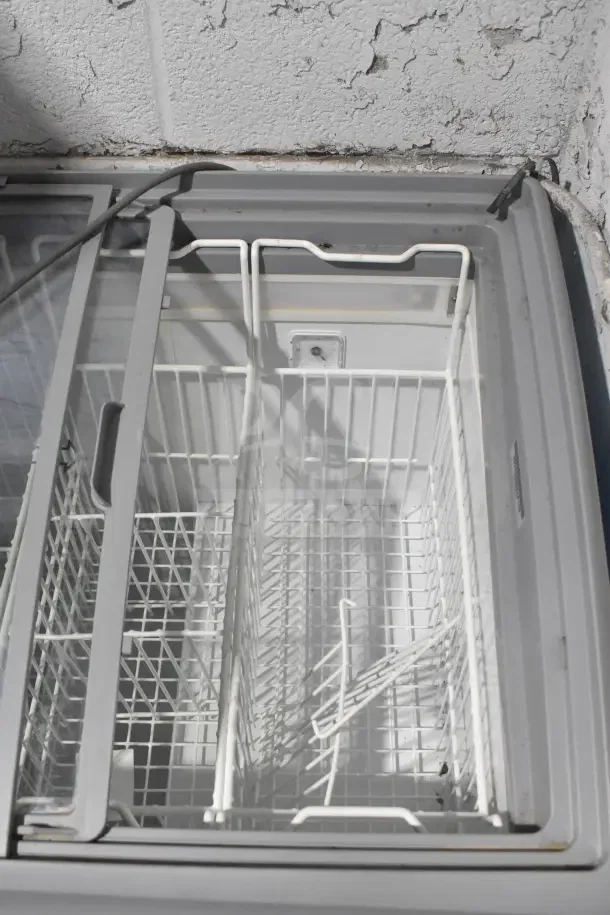 AHT RIO S commercial chest freezer with sliding glass doors, white wire baskets, and commercial casters. 115 volts, 1 phase.