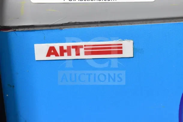 AHT RIO S commercial chest freezer with sliding doors, AHT logo visible. Set on casters, 115V, 1 Phase.
