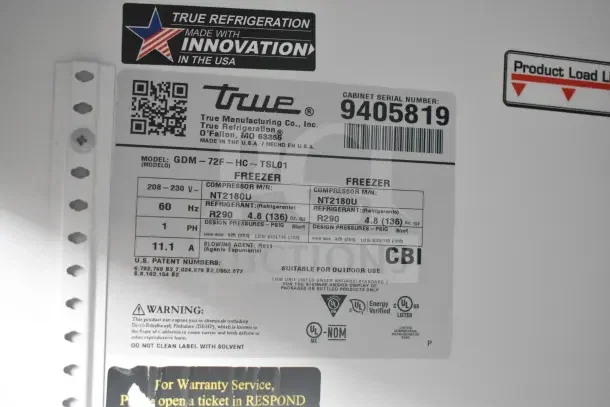 2018 True GDM-72F-HC freezer label showing model details, 115/208-230 volts, refrigerant info, and serial number 9405819.