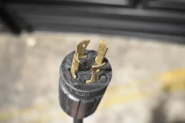 Close-up of a power plug for a 2018 True GDM-72F-HC commercial freezer, showing prongs and housing, indicating tested and working condition.