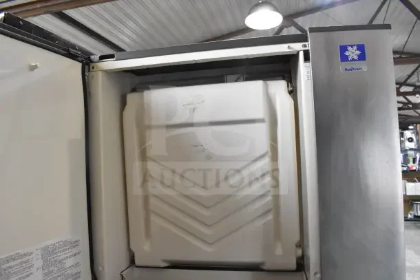 Manitowoc SY0874C commercial ice machine head on ice bin, stainless steel, visible Manitowoc logo, good condition.