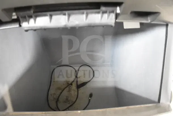 Manitowoc SY0874C commercial ice machine head on ice bin, interior view, shows some dirt and a cable.