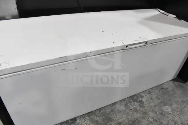 Frigidaire Commercial Chest Freezer, 115 Volts, 1 Phase. Shows signs of wear on lid. White exterior.