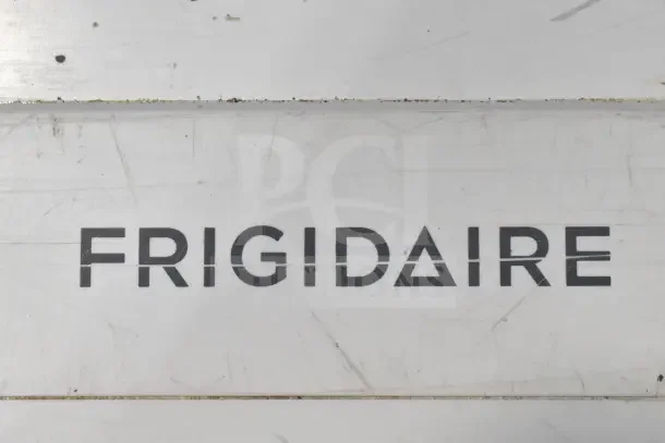 Frigidaire Commercial Chest Freezer, white exterior, faint surface scratches, 115 volts, 1 phase, logo visible.