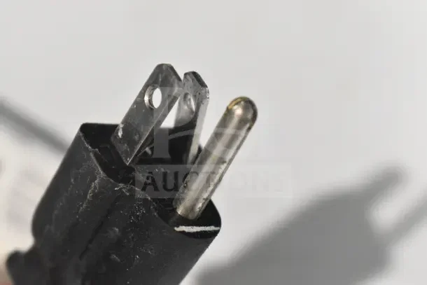 Close-up of a power plug for a Frigidaire Commercial Chest Freezer, 115 volts, 1 phase. Plug shows signs of wear.