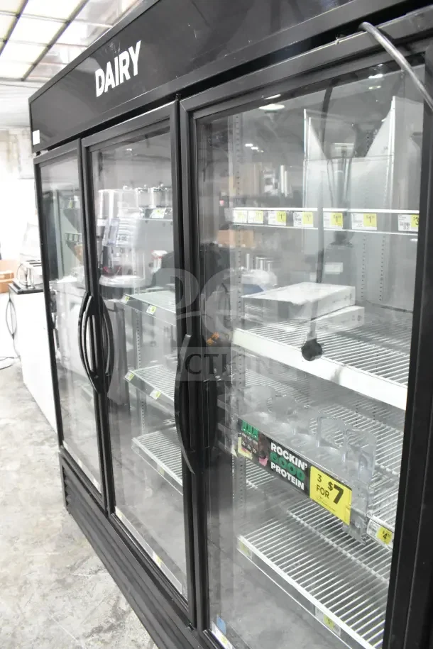 2018 True GDM-72-HC commercial 3-door reach-in cooler merchandiser. Black frame, glass doors, shelves visible inside.