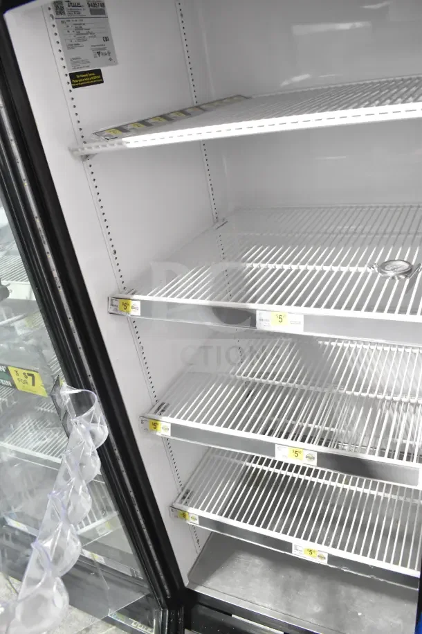 2018 True GDM-72-HC commercial 3 door reach-in cooler merchandiser, white interior, visible pricing labels, 115 volts, 1 phase.