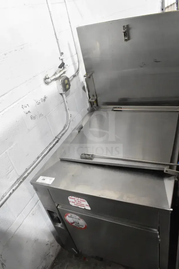 Commercial floor style donut fryer, stainless steel, with hinged lid. Labels warn "Under 18 Years Do Not Operate This Equipment."