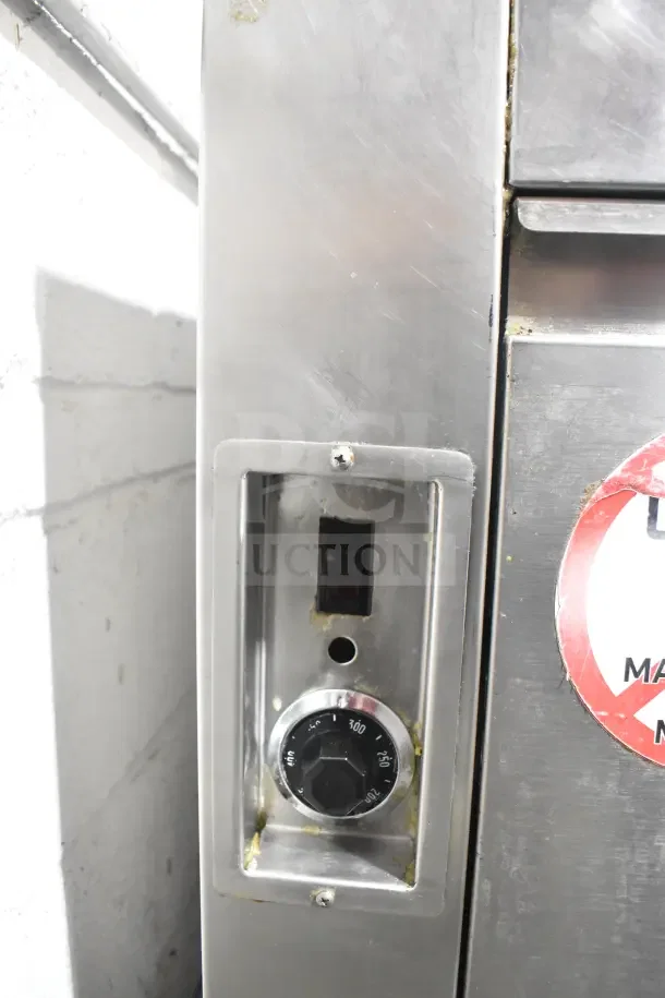 Commercial floor-style donut fryer, stainless steel with temperature dial, showing signs of use. Suitable for high-capacity frying.