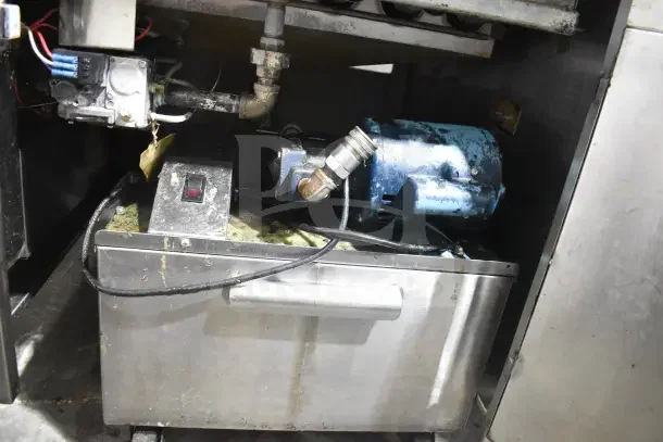 Commercial floor style donut fryer with stainless steel exterior, visible motor and wiring, showing signs of use.