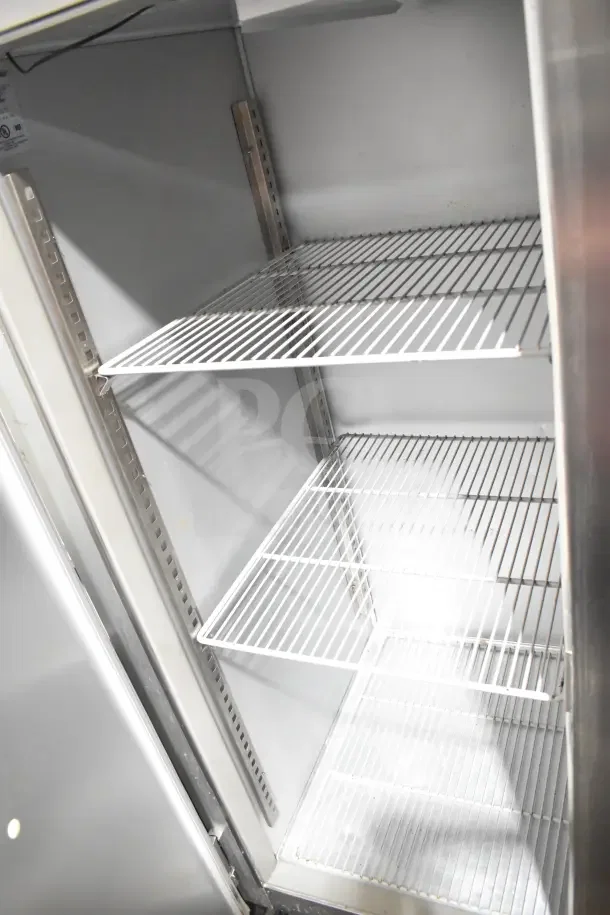 Randell 2020F Commercial 2-Door Reach-In Freezer with adjustable wire shelves, 115 volts, 1 phase, well-maintained condition.
