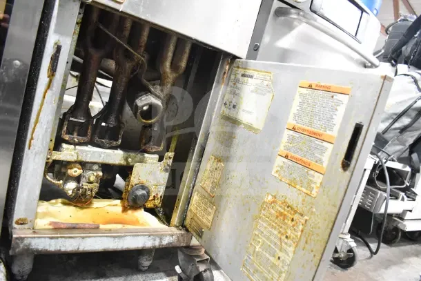 Pitco Frialator 40C deep fat fryer, natural gas, 105,000 BTU. Visible wear and labels. Floor model, door open to show interior.