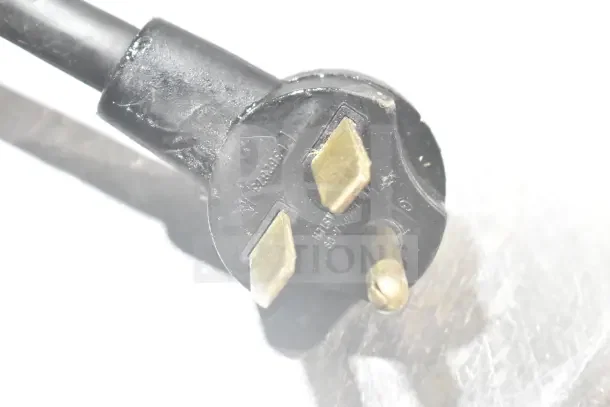 Close-up of a plug for the 2017 Turbochef Encore 2 rapid cook oven, highlighting its three-prong configuration.