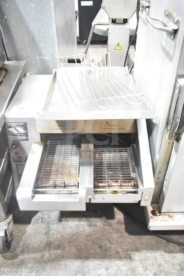 Hatco ITQ-1750-2C dual conveyor toaster with digital controls, stainless steel, used condition, visible caution labels.