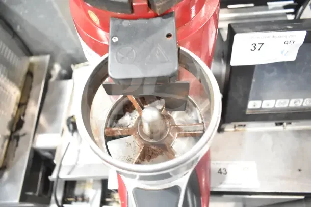 Wega commercial countertop espresso bean grinder base, red, 115 volts, 1 phase, showing grinding mechanism, used condition.