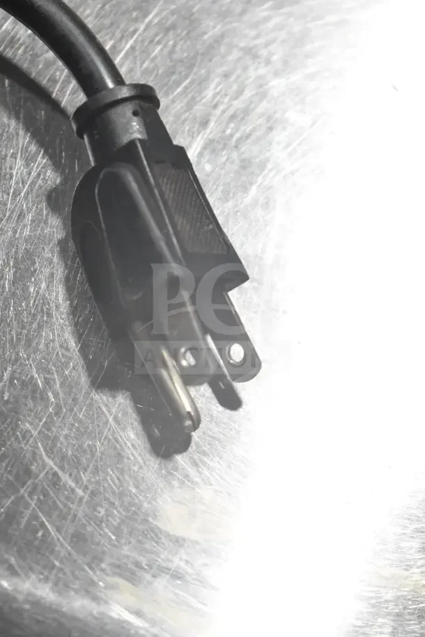 Plug of a Wega Commercial Countertop Espresso Bean Grinder Base, 115 volts, visible on a metal surface.