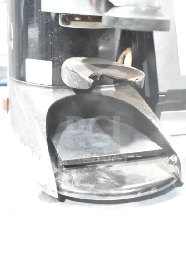 Wega commercial countertop espresso bean grinder base, black, 110 volts, 1 phase. Visible wear, sturdy construction.