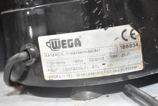 Wega commercial countertop espresso bean grinder base, 110V, 1 phase. Visible label: "Wega," power details, and serial number.
