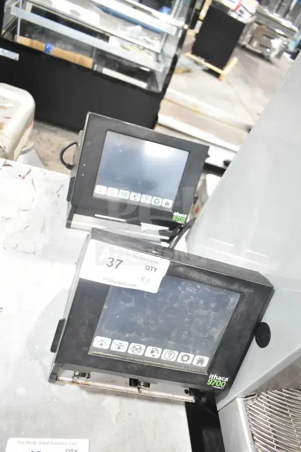 2 Ithaca 9700 food prep labelers, electronic screens, used condition, auction lot tag 37 marked by PCI Auctions.