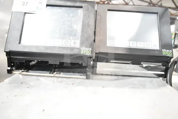 Two Ithaca 9700 food prep labelers by Transact, showing screens and labeling mechanisms, in used condition.