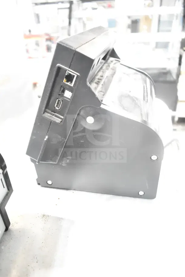 2 Transact Ithaca 9700 Labelers, black, side view showing ports, used for food prep, surface wear visible.