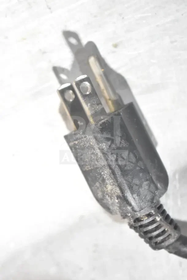 Close-up of a power plug from a 2 Transact Ithaca 9700 food prep labeler, showing slight wear.