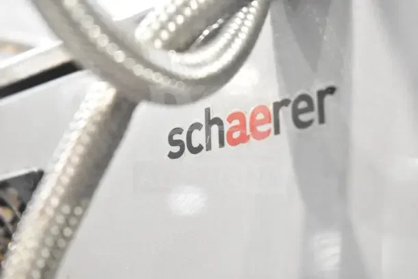 Schaerer SCA1 Coffee Art Commercial Espresso Machine with logo, close-up showing brand detail and braided cables.