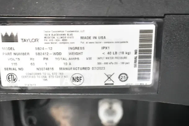 2023 Taylor SB24-12 countertop frozen beverage machine, 115V, 1 Phase, tags show model, serial number, manufactured 07/2023.