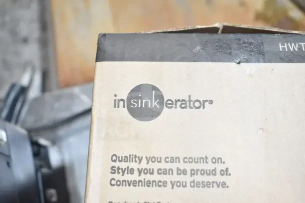 Original Insinkerator HWT instant hot water tank box. Features branding and product details. Box appears slightly worn.