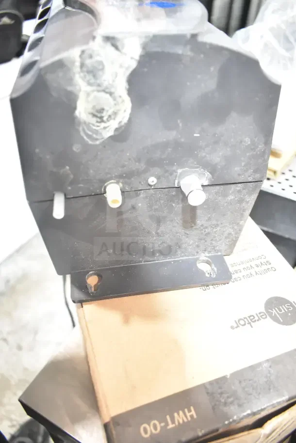 IN ORIGINAL BOX! Insinkerator HWT Instant Hot Water Tank, black unit, piping connectors visible, new condition.